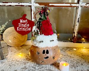 This image shows a Christmas Elf Decoration. It is made using a dried gourd. The elf is named Zingle Kringle and is wearing a handmade hat. 